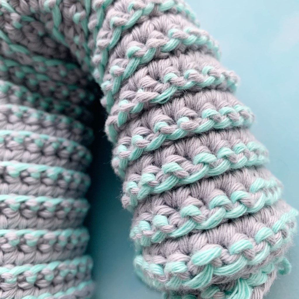 close up of crochet work, highlighing yarn under double crochet